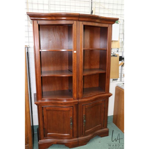 Two piece curved front wall unit with lower drawers and upper display shelves, total measures of uni