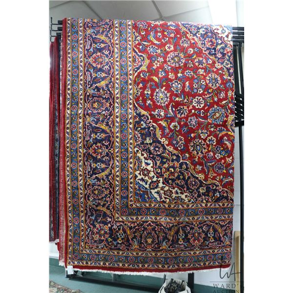 Iranian wool carpet "Kashan' with center medallion, red background, overall floral design and highli