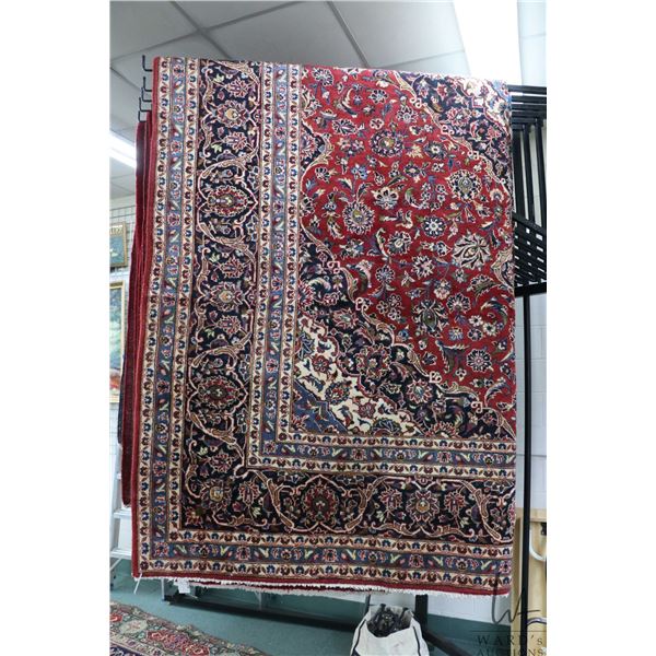 Iranian wool carpet "Kashan" with center medallion, red background, overall floral design and highli