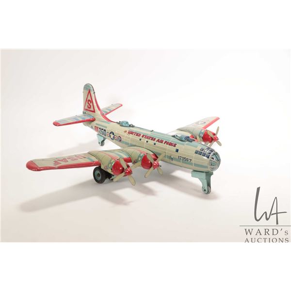 Vintage United States Air Force BK 250 friction tin plate airplane by Japanese company Yonezawa, 19"