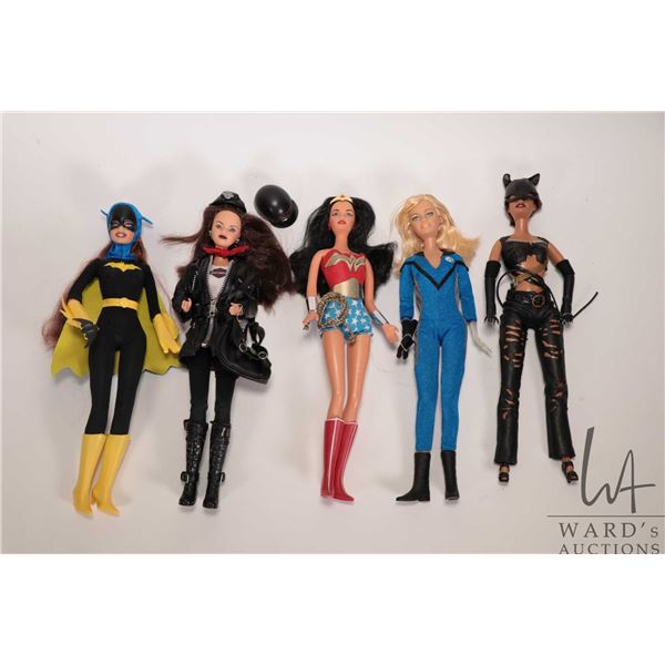 Five collectible Barbie dolls including Batwoman, Wonder Woman, Invisible Woman, Cat Woman, and a Ha