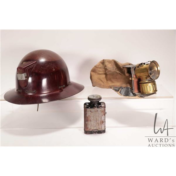 Antique bakelite miners pit helmet, a antique miners cap with gas light, and a Daimon Contact flashl