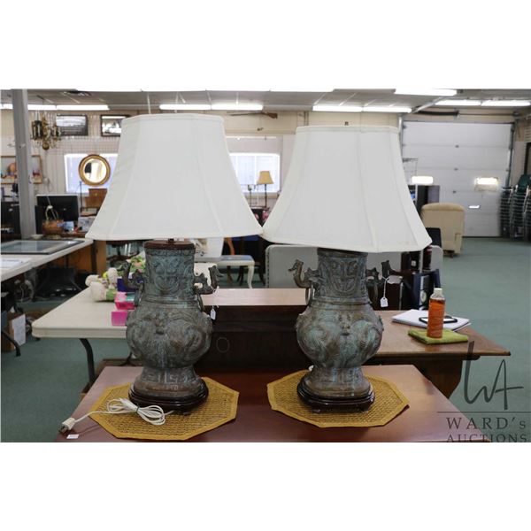 Two heavy bronze Chinese style lamps consignor purports "featuring archaic-style case bronze ritual 