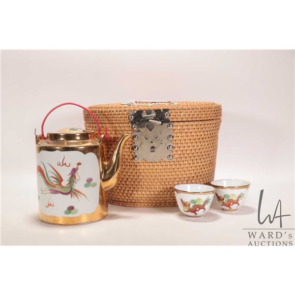Vintage Chinese wicker tea basket with teapot and two cups