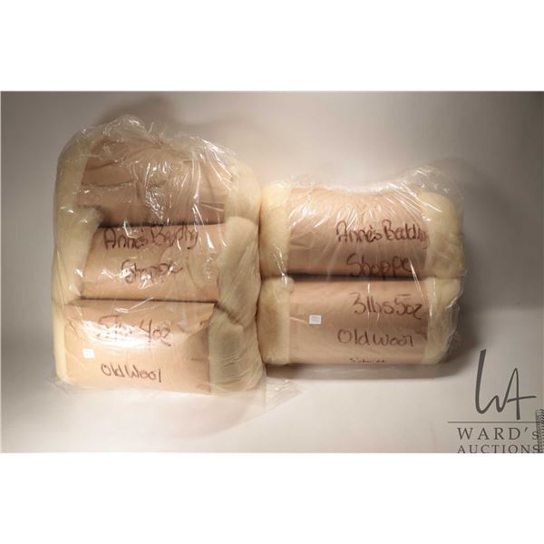 Two bags of wool batting including bag containing four rolls totaling 5 lbs. 4 oz and a bag containi