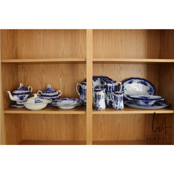 Shelf lot of vintage and antique blue and white pottery including Flow Blue, teapot, large lidded su