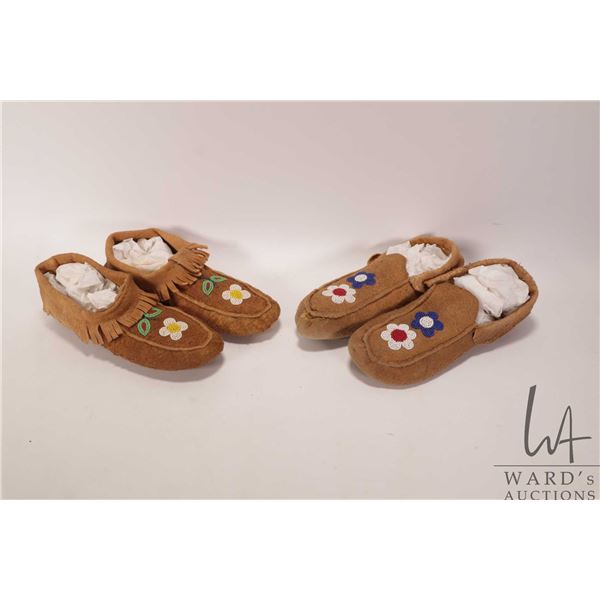 Two pairs of possibly moose hide moccasins with floral bead work including 9" in length and 9 1/2"