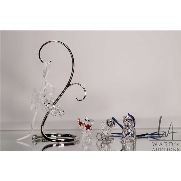 Four Swarovski crystal teddy bear hanging ornaments and an ornament hanger. Incudes original boxes