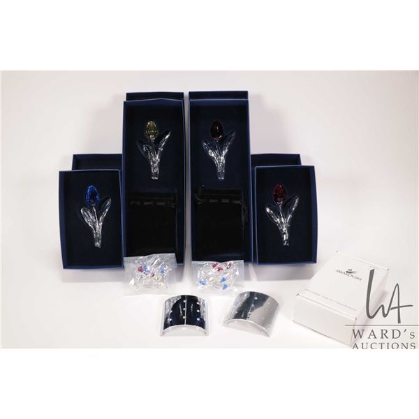 Four Swarovski crystal collectible tulips, each 3 1/2" in length plus two sets of 9 mini tulips and 