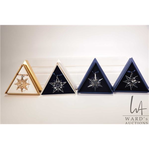 Four Swarovski crystal Christmas ornaments including 2001 and 2005 and two 2009 including gold and c