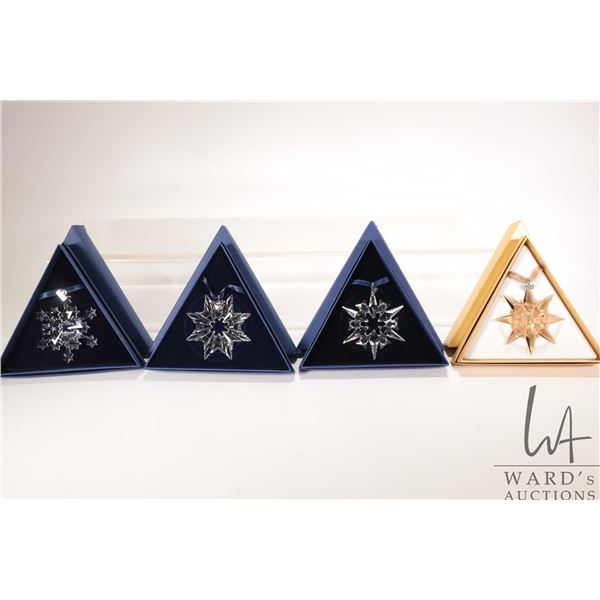 Four Swarovski crystal Christmas ornaments including 2003, 2004, 2007 and gold 2009