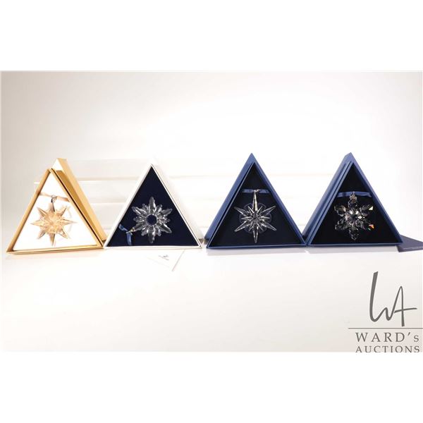 Four Swarovski crystal Christmas ornaments including 1998, 2005, 2008 and gold 2009