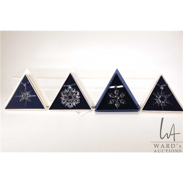 Four Swarovski crystal Christmas ornaments including 1995, 1997, 1999 and 2010