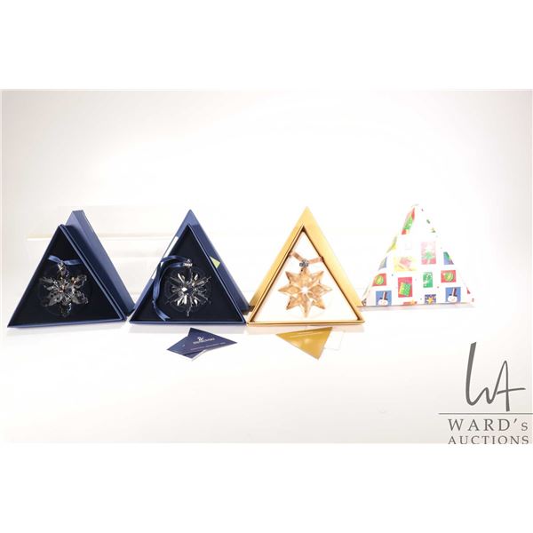Four Swarovski crystal Christmas ornaments including hand signed 2006, 2008, 2013 and a mystery gift