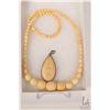 Image 1 : Graduated beaded ivory 17" necklace and a hand carved pendant. Can not be shipped outside of Canada.