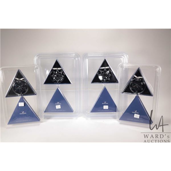 Four new in package Swarovski crystal Christmas ornaments including two 2012 and two 2013