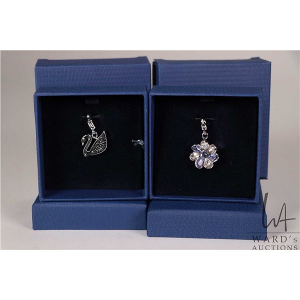 Two Swarovski hanging charms including Purple Renee Charm and Black Swan