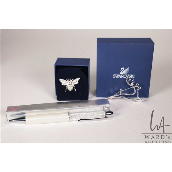 Swarovski crystal beaded bee and a stylized Swarovski deer brooch plus a Swarovski ball point pen