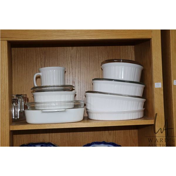 Selection of vintage cookware including five lidded casseroles, graduated measuring cups etc.