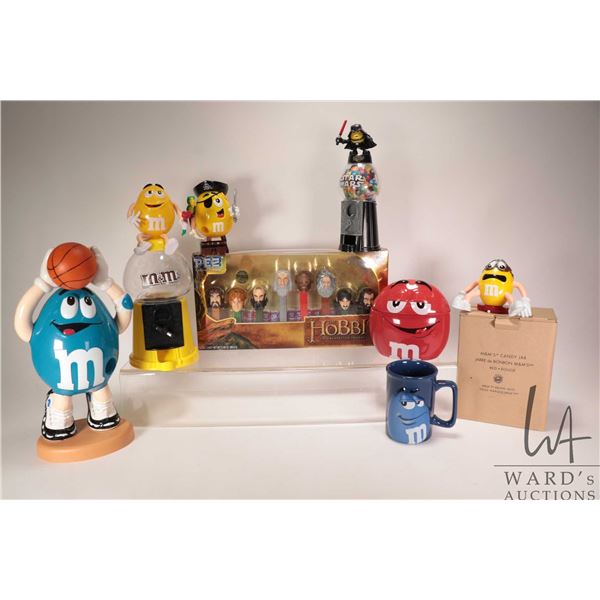 Selection of M & M Chocolate collectibles including dispensers, figures, lidded jar, mug, candy jar 