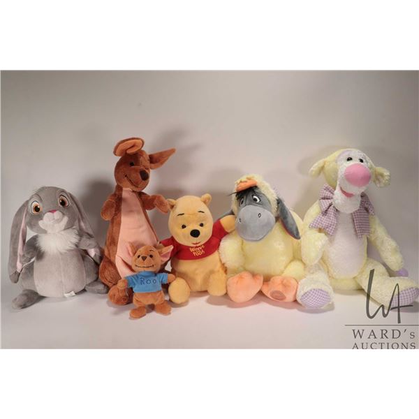 Six Winnie-the-Pooh stuffed animals including Winnie, Eyore, Tigger, Rue and Mama and Rabbit