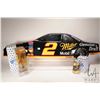 Image 1 : Three Rusty Wallace 1: 64th scale collectibles including Miller Genuine Draft car in bottle, plus ca