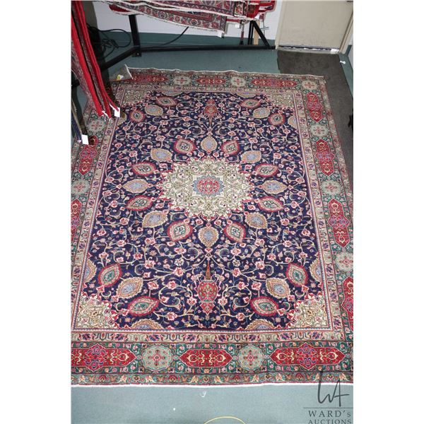 100% Iranian hand made wool carpet Tabriz with center medallion, blue background and highlights of r