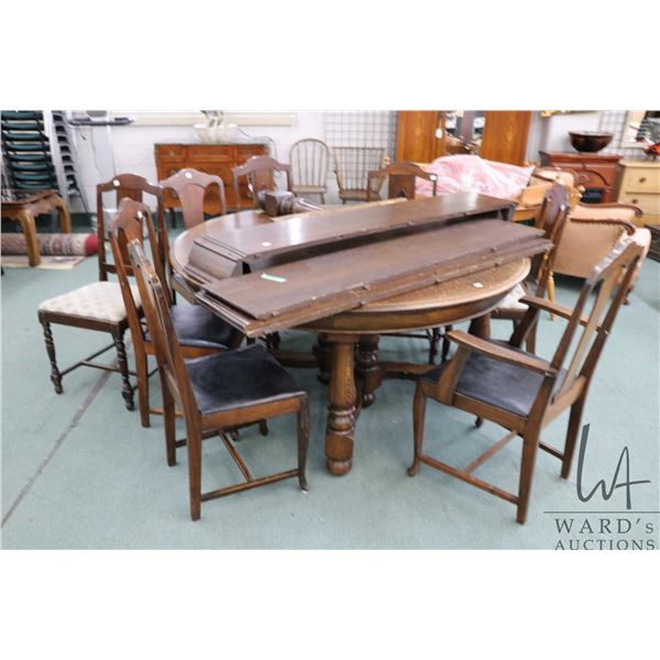 Fabulous 60" diameter, quarter cut oak antique dining table with three 12" non-skirted leaves and tw
