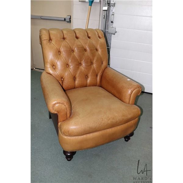 Quality two tone leather upholstered club style parlour chairs with decorative nail head beading and