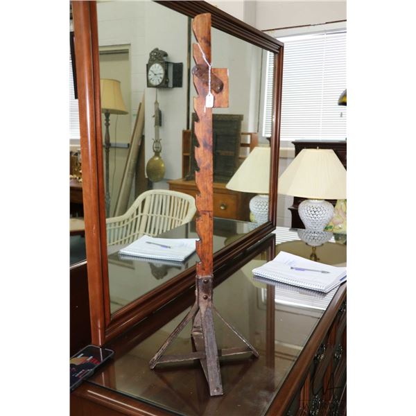 Antique ratcheting wooden candlestick holder with metal base featuring hand hammered rivets, circa 1