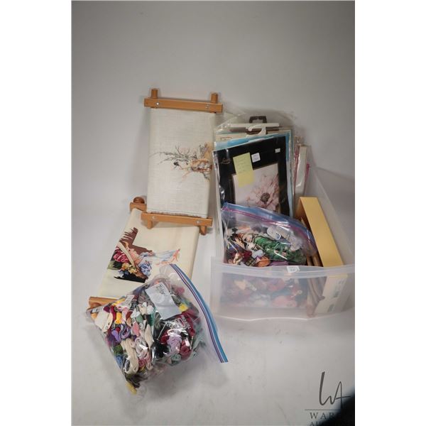 Selection of needlecraft kits and two large bags of embroidery floss plus two started embroidery pro