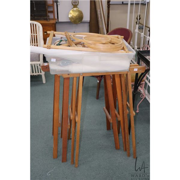 Two wooden trestle sets and a large selection of embroidery hoops, framed and Aida cloth etc.