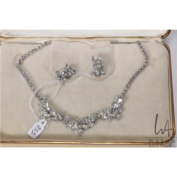 Signed Sherman silver tone necklace with marquise-cut crystals and matching earring and includes "Je