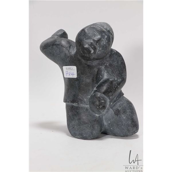 Inuit soapstone carved figure of a man, signed in syllabics, 7 1/2" in height