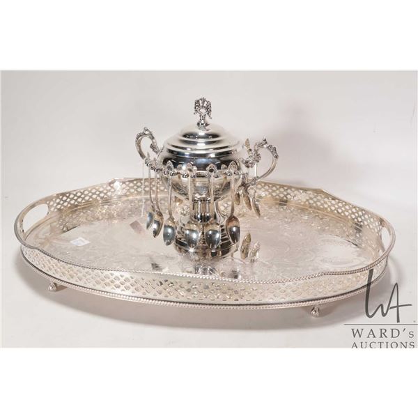 Silver plate lidded sugar bowl with twelve teaspoons and a silver plate oval serving tray with scrol