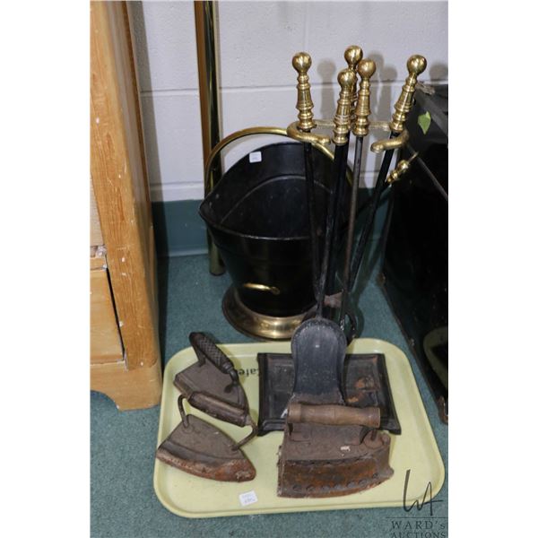 Three antique sadirons, three piece companion set plus coal hod with brush