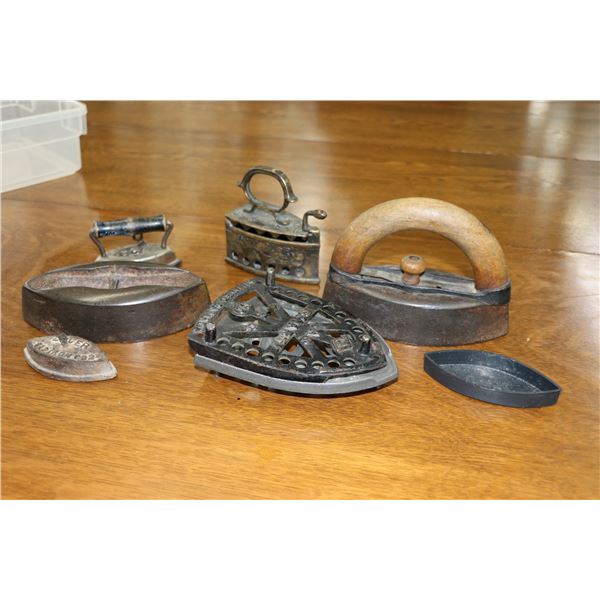 A selection of vintage and antique irons including sadiron and trivets, small brass iron etc.