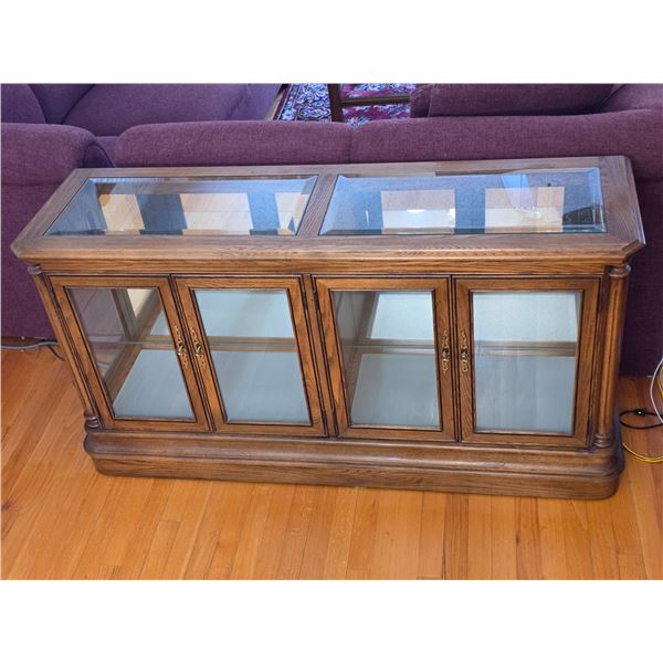 Solid wood and beveled glass lighted display cabinet- 56" by 16" by 30"H- has mirrored back, lights