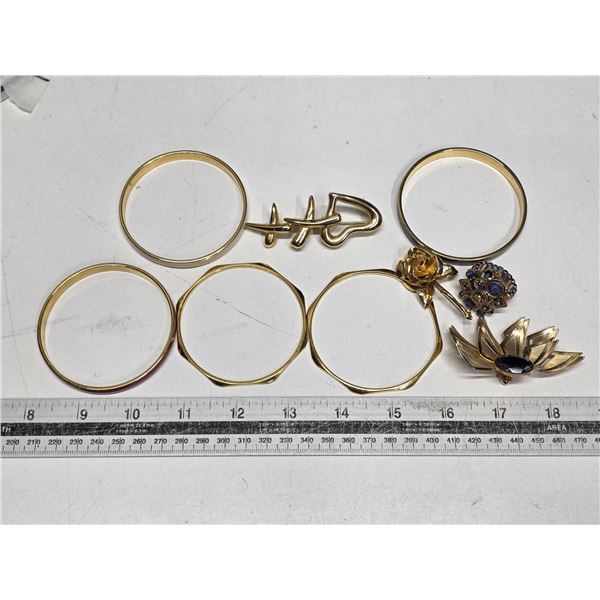 Gold colored brooches and bracelets