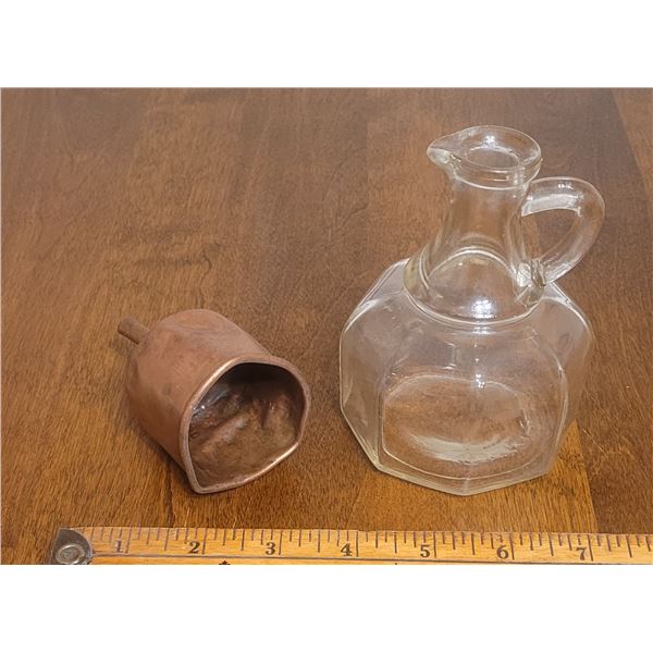 Small clear glass pitcher and copper funnel