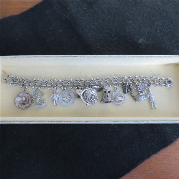 STERLING Vintage charm bracelet with 11 charms.  Beautiful!  Marked Sterling