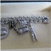 Image 5 : STERLING Vintage charm bracelet with 11 charms.  Beautiful!  Marked Sterling