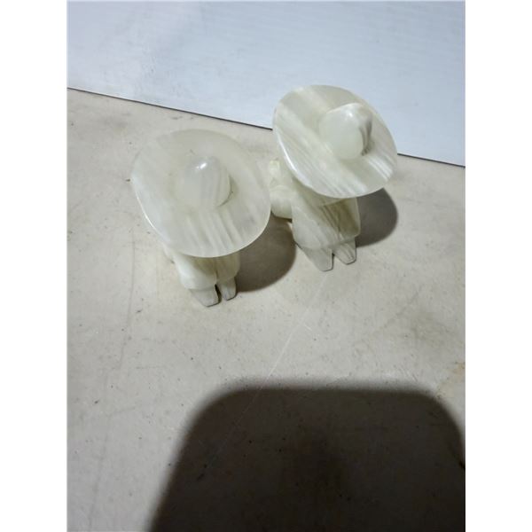 vintage figures are carved onyx bookends depicting a resting man in a sombrero.