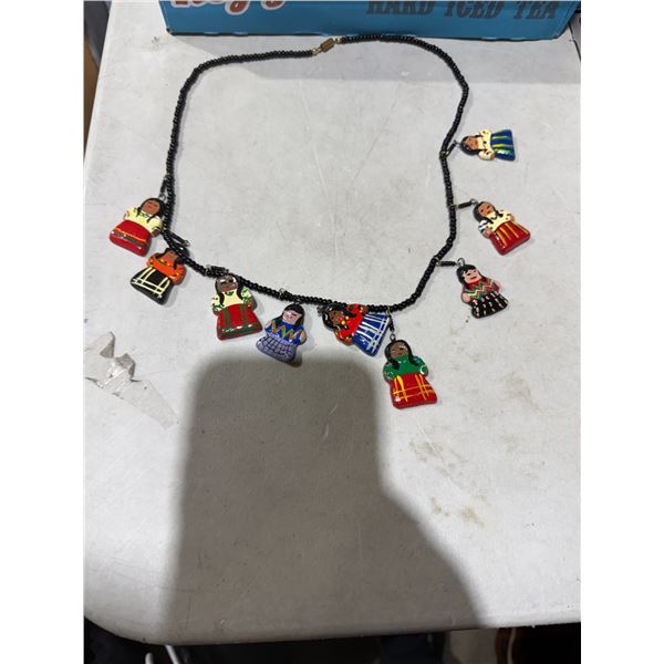 vintage Native American seed bead necklace featuring hand-painted clay doll charms.
