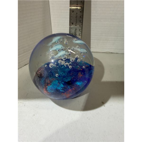 hand-blown art glass paperweight featuring dolphins and fish in an ocean coral reef scene.