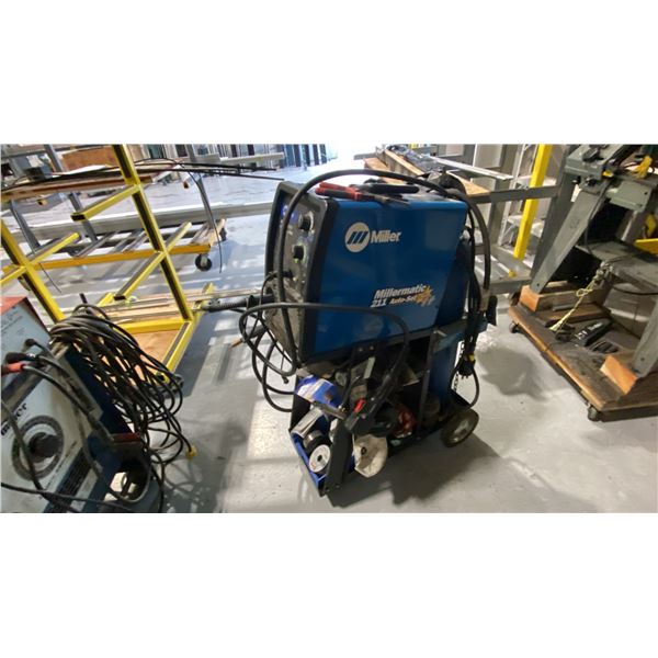 MILERMATIC 211 AUTOSET WITH MVP WIRE FEED WELDER ON WHEELED CART WITH GAUGES, HELMET. TANK