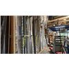 Image 1 : LARGE GROUP OF ALUMINUM EXTRUSIONS LEANING ON WALL IN BAY 1. INC WALL DIVIDING HARDWARE WHICH