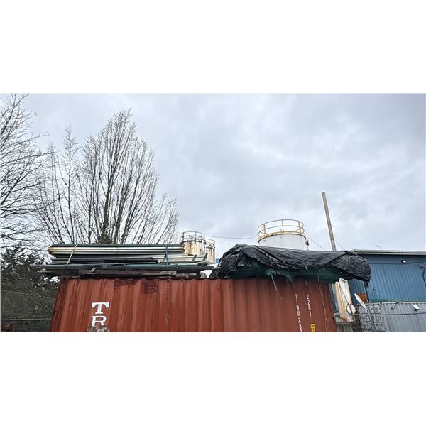 GROUP OF ITEMS ON TOP OF CONTAINER. RACKING COMPONENTS, PLYWOOD, SCRAP METAL