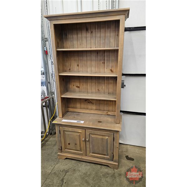 Stripped pine step back cupboard , three upper shelves, and a base cabinet with panelled doors (76"H