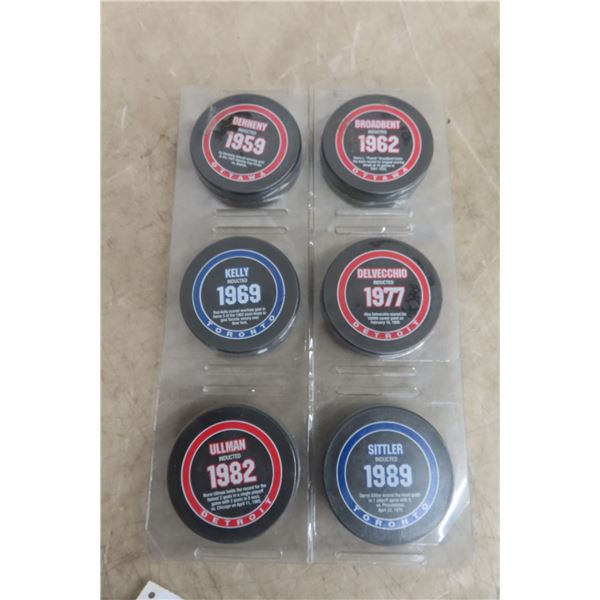 Six Hockey Hall of Fame Pucks With Names and Years of Induction